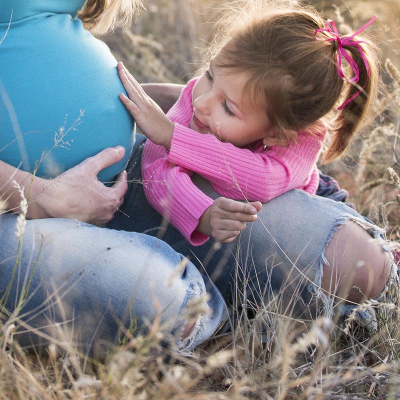 Pregnant mom and girl.